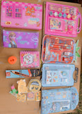 Collection of stationery items including books, pencils, and stationery sets on a wooden surface.