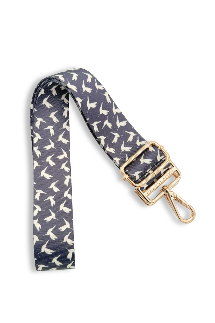 Hummingbird-patterned strap with gold clasp on a white background.