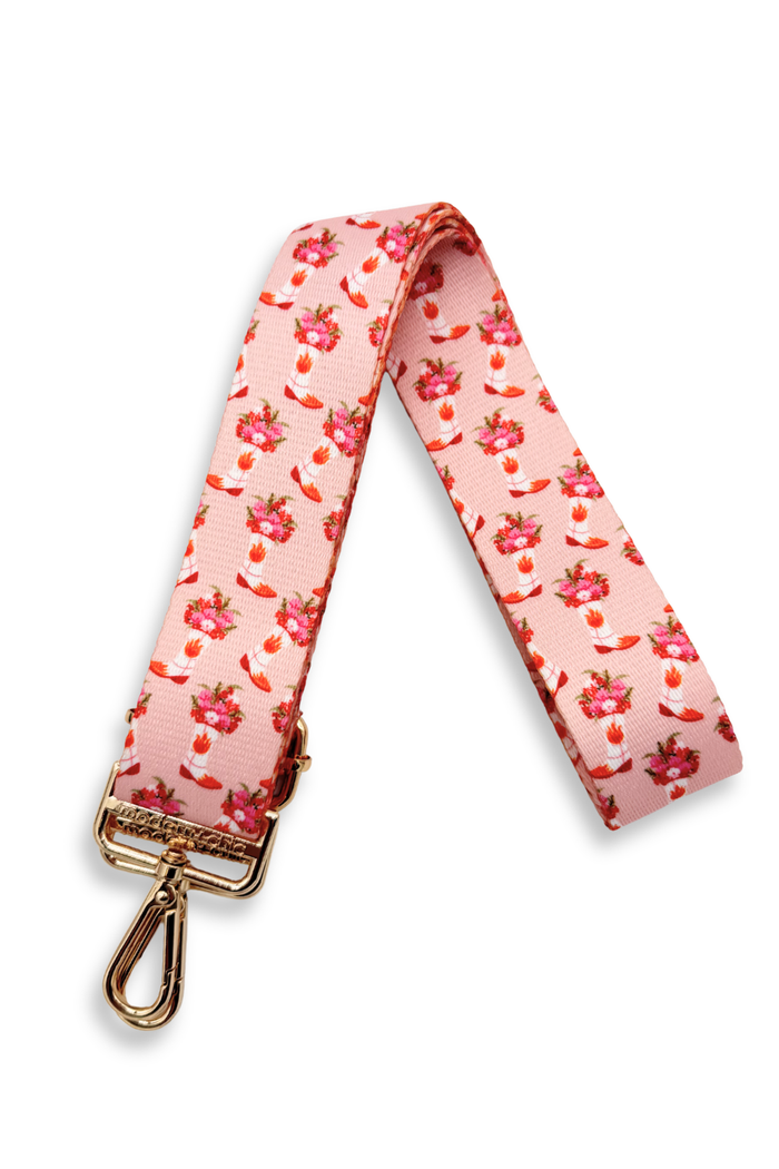 Pink floral and cowboy boot patterned strap with a gold clasp on a white background