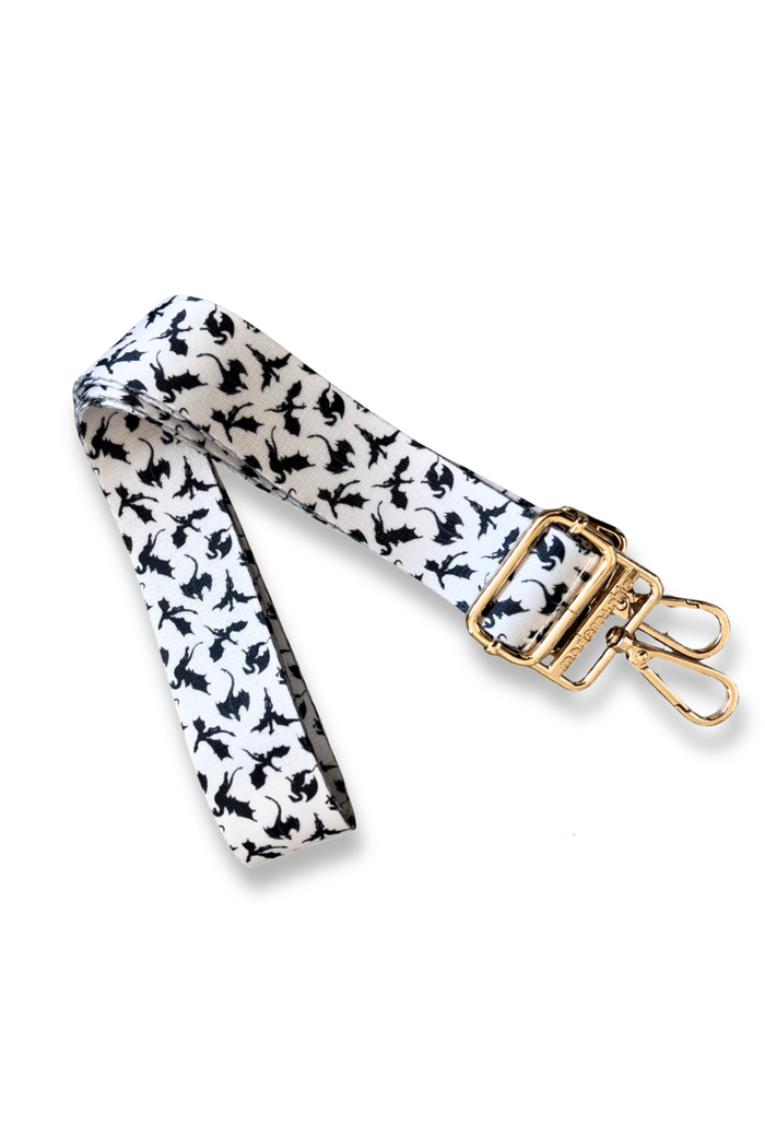 Patterned dragon strap with a gold clasp on a white background