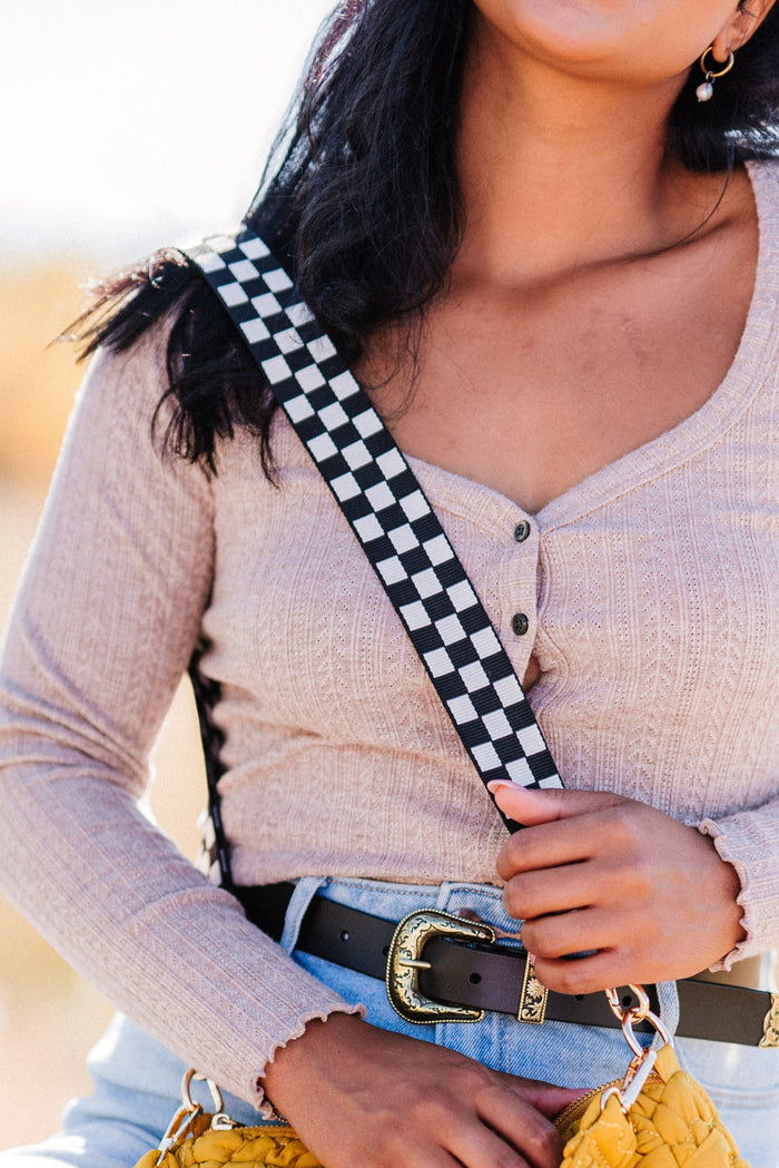 Woman is wearing a Black and white Modern + Chic Lizzie Checkered Purse Strap for Crossbody Bags.