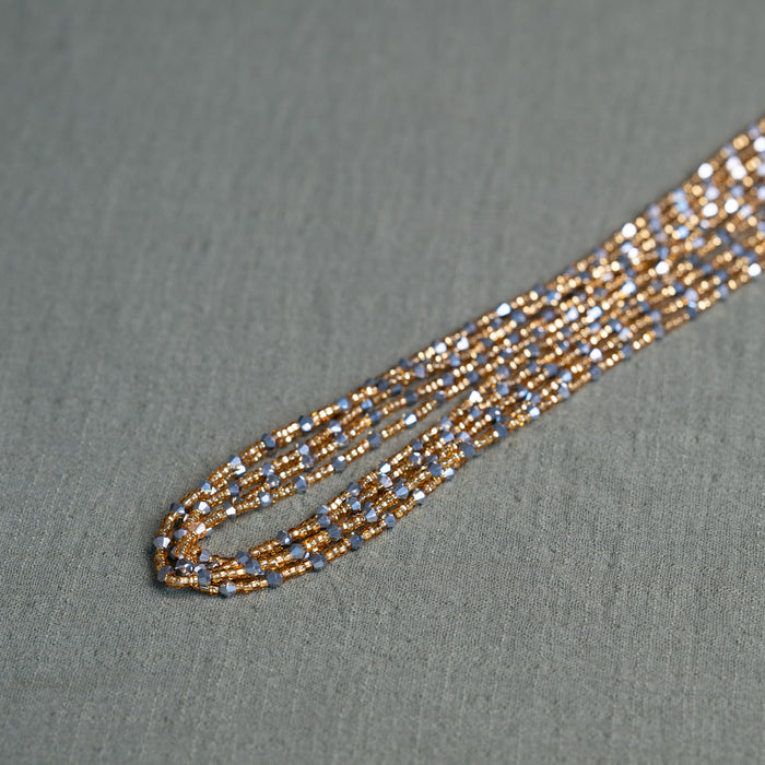 Handmade African waist beads in silver-grey and gold tones – tie-on body jewelry from Ghana for spiritual strength and balance.