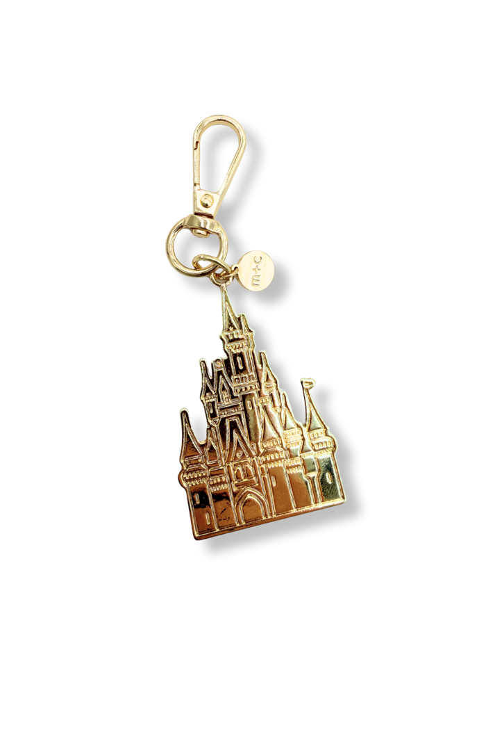 Modern + Chic Palace Charm – Gold castle-shaped keychain on a white background.