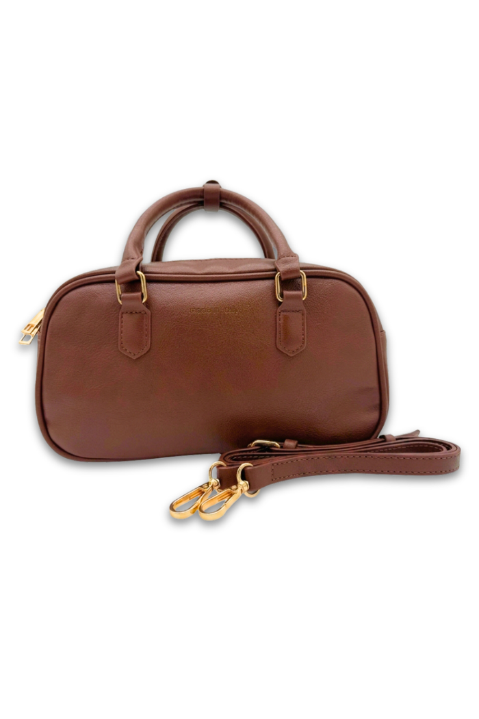 Brown leather handbag with a strap on a white background